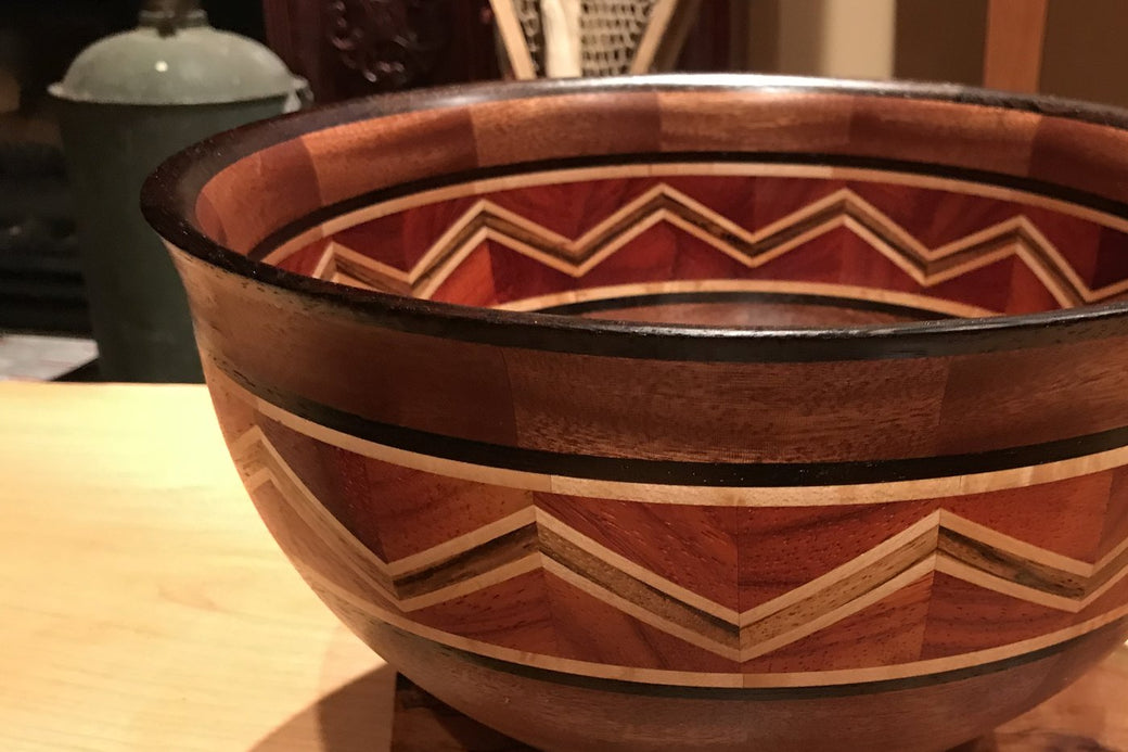 Segmented sapele bowl with a chevron feature ring in padauk, zebra, maple and ebony