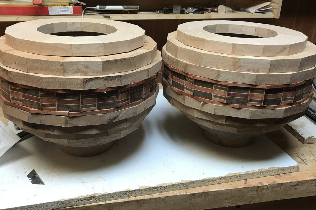 The same segmented bowl blanks before turning, glued up and rough-shaped on the bench